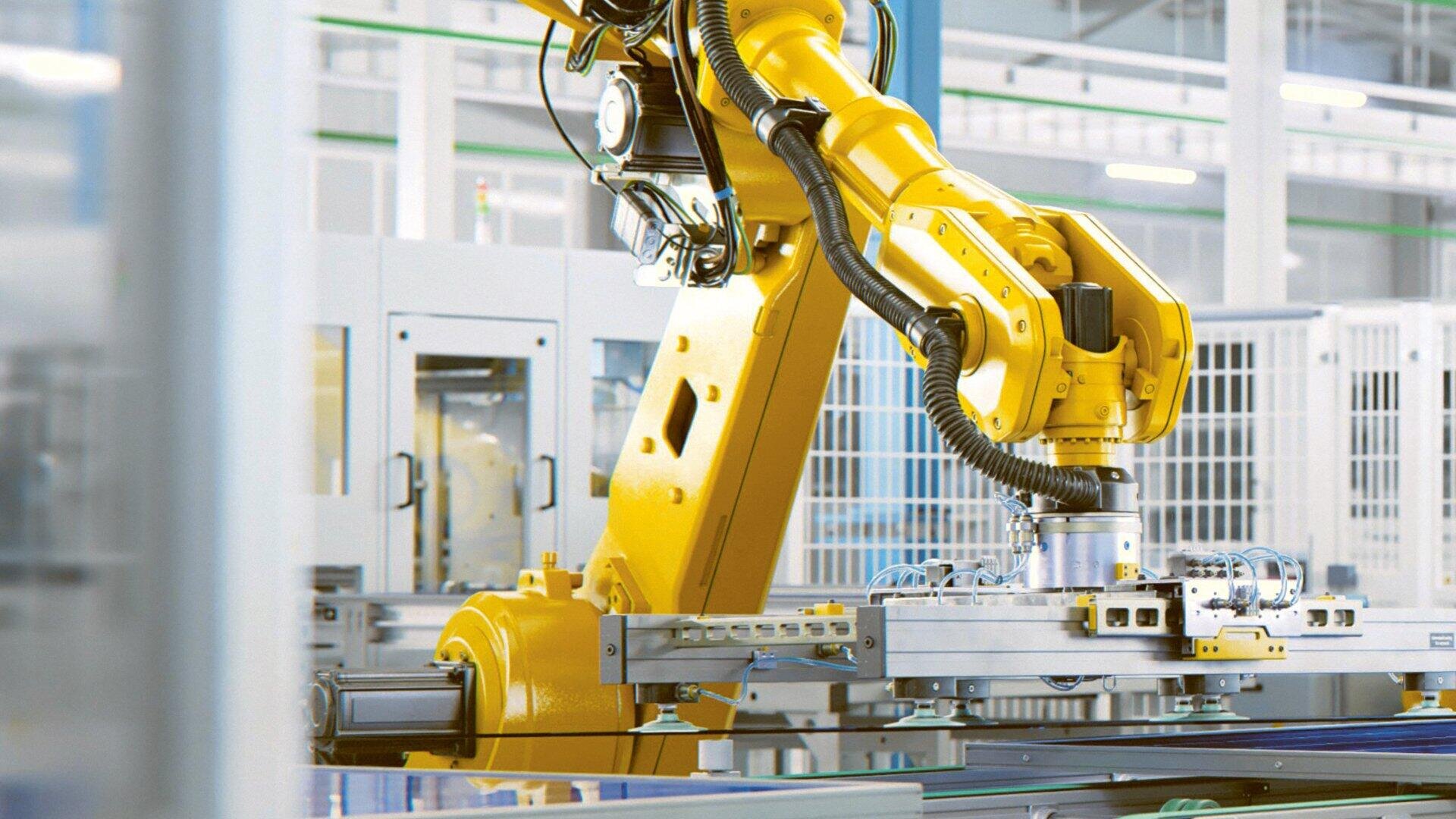 Ein gelber Roboterarm ist in einer Industrieanlage im Einsatz und handhabt Maschinenteile präzise in einer hellen, modernen Produktionsstätte.