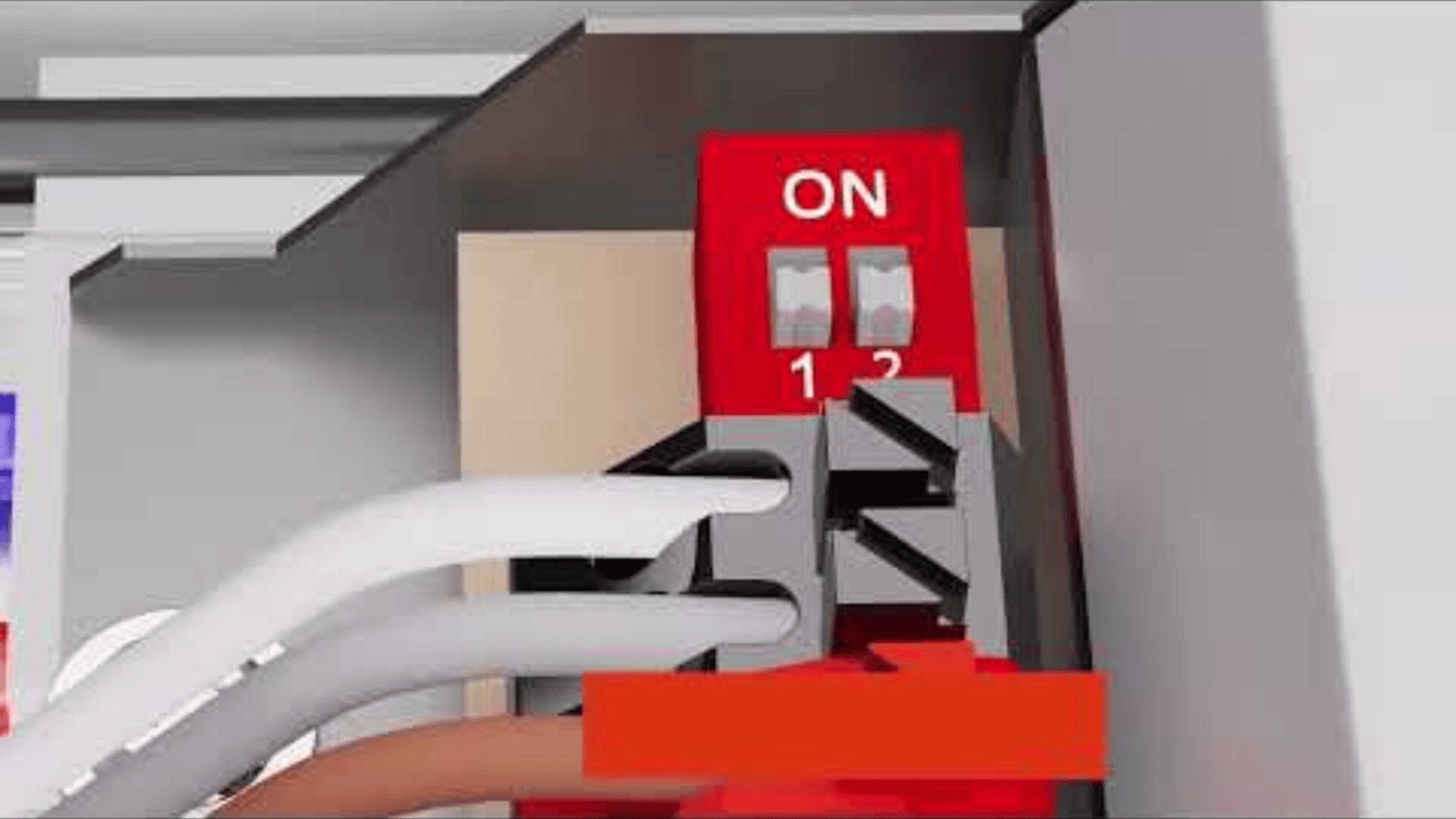 Nahaufnahme einer elektrischen Verdrahtung, die an eine Klemmenleiste mit einem roten Schalter mit der Aufschrift ON und den Nummern 1 und 2 innerhalb eines Metallgehäuses angeschlossen ist. Weiße und braune Drähte sind in die Klemmen eingesteckt.